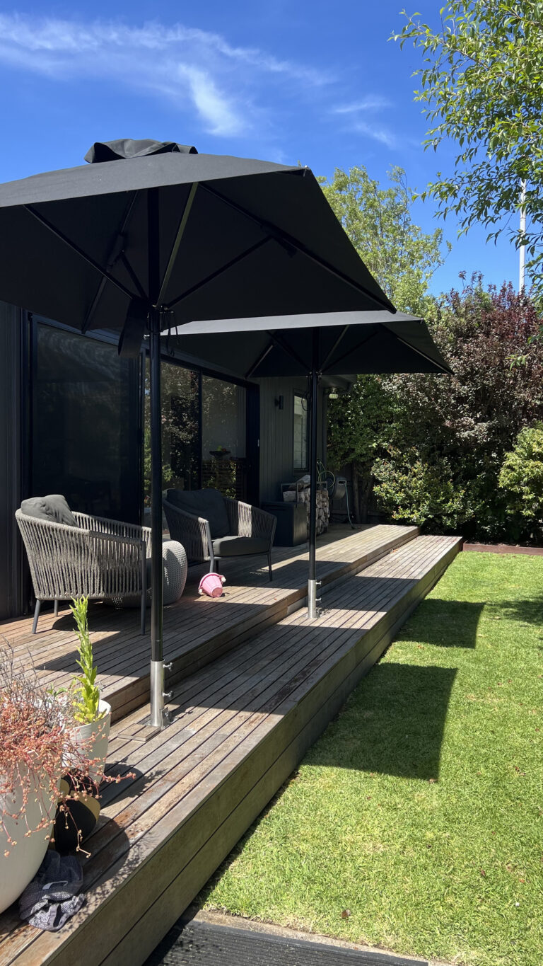 Black PVC universal umbrella cover fitted over 3m square outdoor umbrella